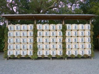 Decorative sake barrels, or kazaridaru, are stacked throughout the complex
