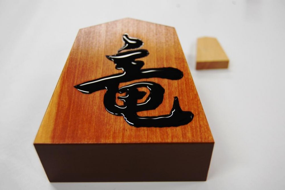 My freshly painted shogi piece; the paint is still wet - Tendo Town, home of Japanese chess