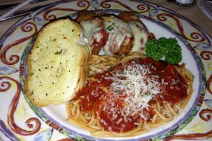 Chicken parmesan served with spaghetti marinara and garlic bread