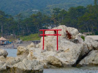 Red torii (Shinto gate) on the rocks