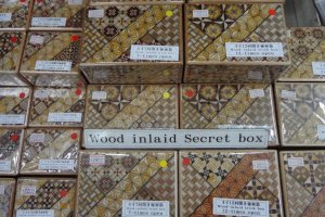 Mosaic work with parquetry-like patterns adorn these boxes. The box itself is a puzzle.