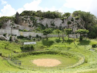 The bullfighting arena is back dropped by the Agena Castle Ruins