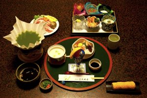 Multi-course Japanese dinner; here we have the appetizers and the green tea, the pork and vegetables needed to prepare the cha-shabu—delicious!