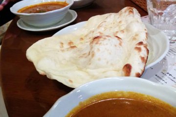 <p>Massive naan bread and your choice of vegetable, chicken, or seafood curry.&nbsp;</p>