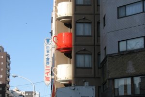 Across the street from the giant chef is a building whose balconies are teacups.