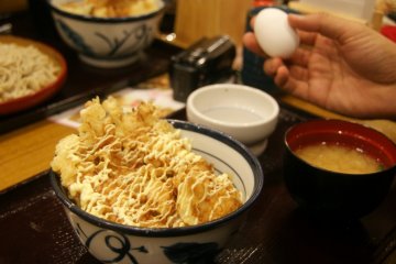 <p>The egg for donburi&nbsp;is a soft-boiled egg so slightly uncooked. You crack the egg and pour it on the donburi.&nbsp;</p>