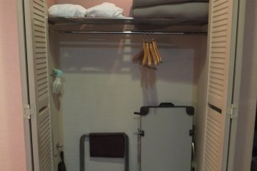 <p>The closet with iron and ironing board, bathrobe, shoe brush and electric foot massage</p>