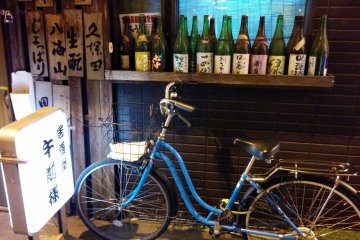<p>A local parks his bike in front of his favorite bar. The ride here was easy, but he will be walking his bike home because of the zero tolerance on alcohol law when operating a vehicle in Japan.&nbsp;</p>
