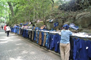 <p>She sells hand made items of indigo dye in front of the animal grave gate</p>