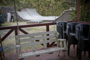 Porch swing and skateboarding ramp