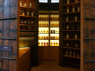 Wooden shelves lined with whiskey bottles create a wonderful atmosphere