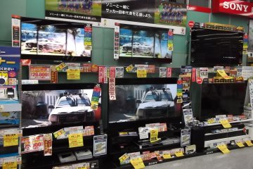 <p>A fraction of the TVs on display at an electronics store</p>