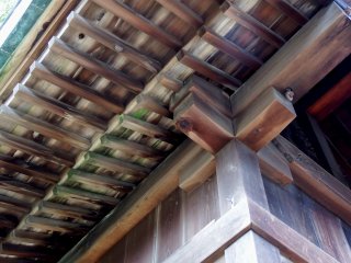 Dưới mái hiên của đại sảnh đền Shirahige. Một phần của nó bị rêu phủ