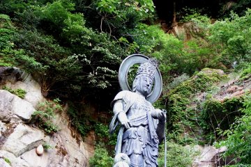 <p>The statue of the Goddess of Mercy for children standing with bare rocks of Mt. Asuwa in the backdrop</p>