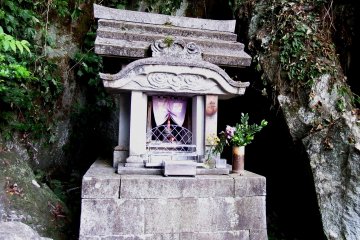 <p>Small stone shrine in the shadow of the mountain cave</p>