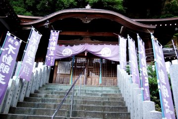 <p>Purple banners line the stone steps to the alter</p>