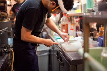 <p>A chef preparing the yakitori for cooking</p>