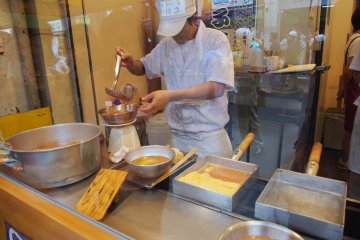 <p>You can watch the popular rolled omelets being made from behind the glass of the stall &ndash; there&rsquo;s quite an art to it</p>