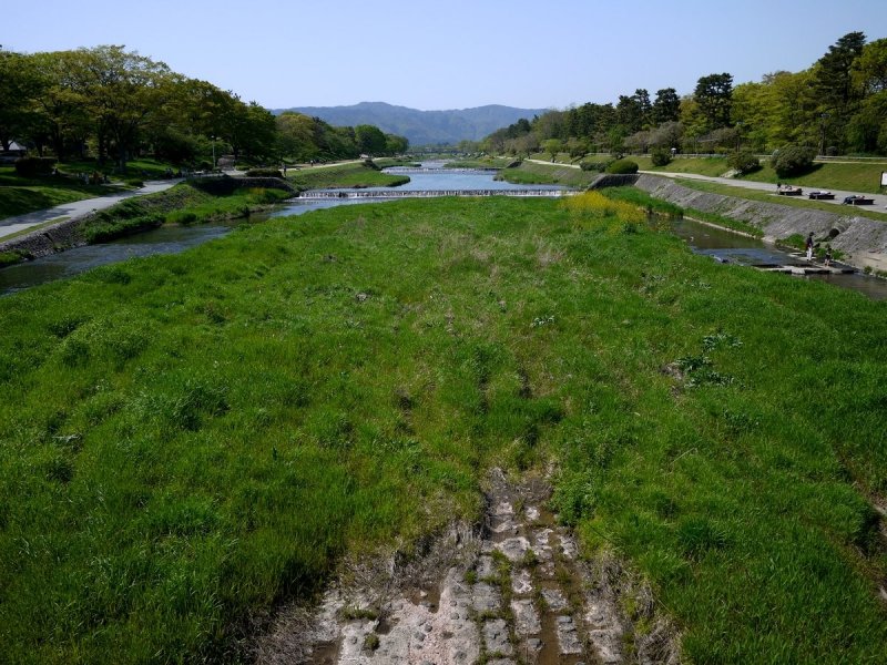 <p>Kamogawa flows from the blue hills north of Kyoto all the way to southern Kyoto</p>