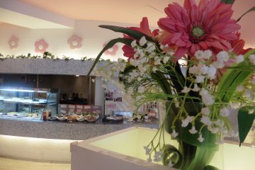 <p>A beautiful flower arrangement and the buffet</p>