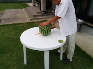Okui-san&nbsp;prepares the watermelon