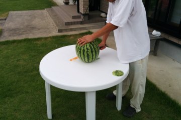 <p>Okui-san&nbsp;prepares the watermelon</p>