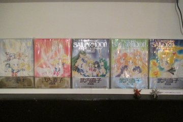 <p>Sailor Moon art books placed in the corner for customers to enjoy</p>