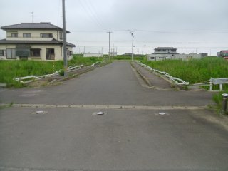 The guardrails on the road leading to the junior high school were flattened - not by the tsunami, but by a house that was carried away in it.