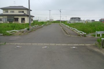 <p>The guardrails on the road leading to the junior high school were flattened - not by the tsunami, but by a house that was carried away in it.</p>
