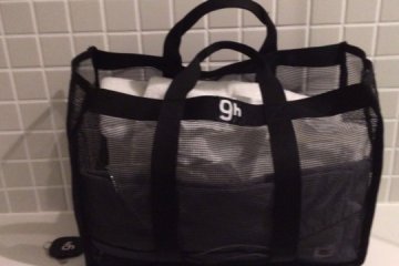 <p>Bag contains pajamas, a toothbrush, toothpaste, small and big towels, and sandals</p>