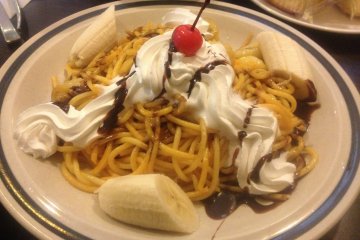 <p>Sweet tasting spaghetti: spaghetti topped with chocolate sauce, whipped cream, and bananas</p>
