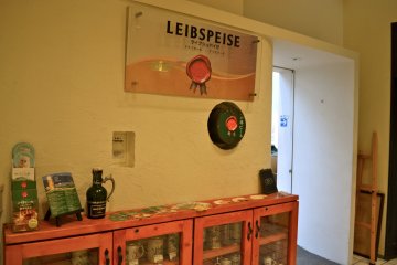 The third-floor entrance to Leibspeise displays a cupboard of beer mugs