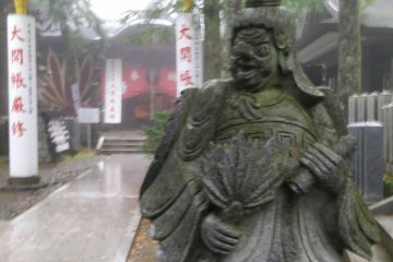 <p>One of a pair of stone guardians at the top of the entrance stairs. The long nosed style tengu</p>