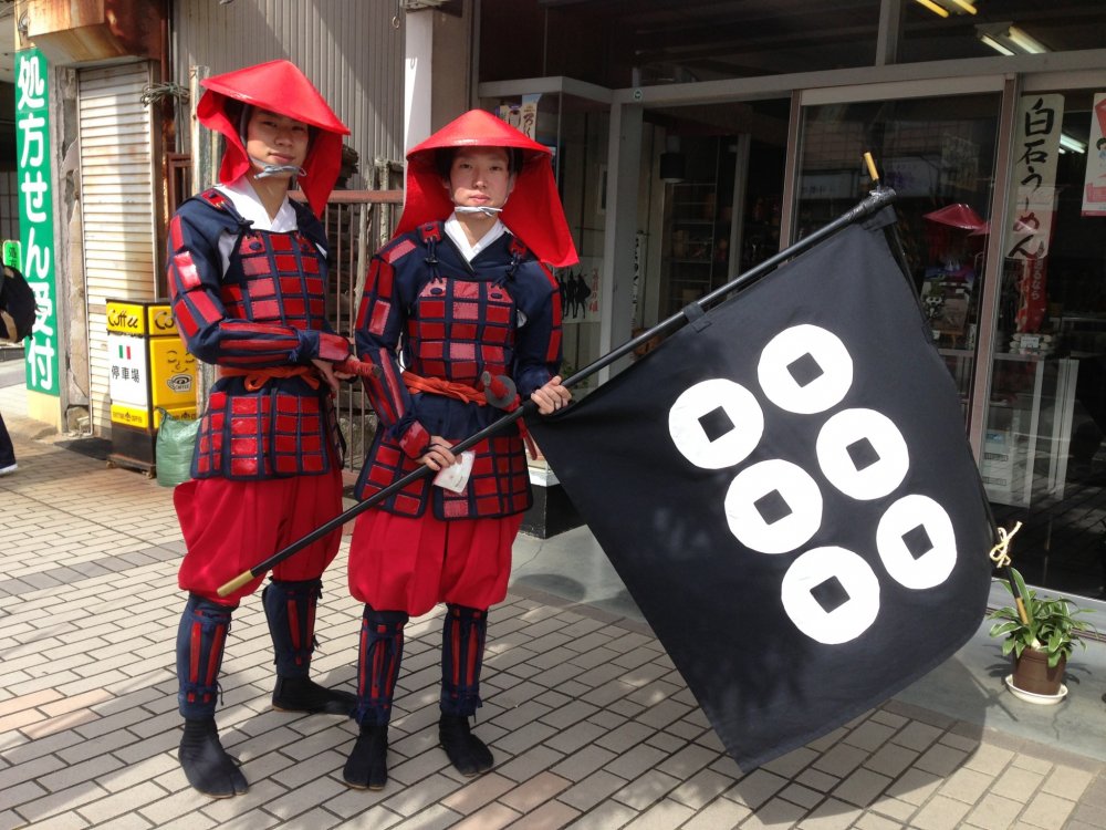 Two members of the Sanada clan pose with their battle flag.
