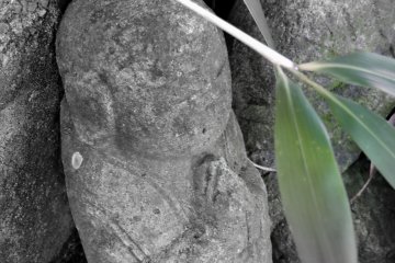 <p>Small jizo statue praying silently in his cemetery</p>