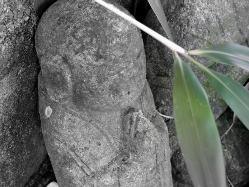 <p>Small jizo statue praying silently in his cemetery</p>