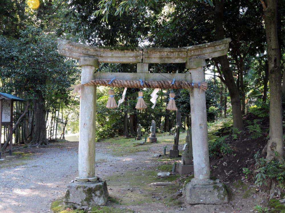 The stone torii gate stands at the entrance of &#39;Thirty-three Kannon Bosatsu&#39; pilgrimage path in the woods