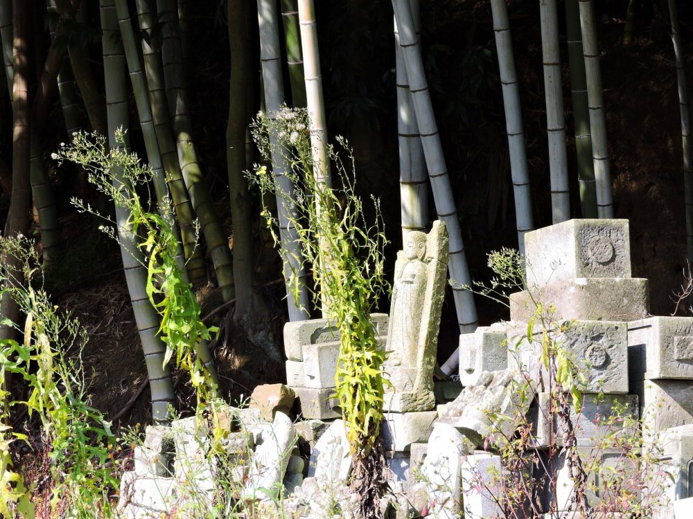 Cemetery of broken jizo statues beside the bamboo grove which surrounds Taicho-ji Temple