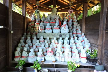 <p>Rows of small jizo statues with the bigger one in the center at the top</p>