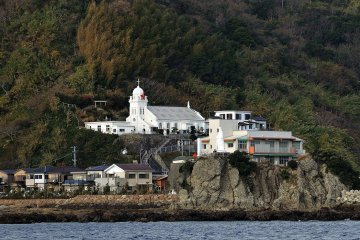 <p>On the way to Gunkanjima, you can see Kaminoshima Church in the center of Kaminoshima Island (left). A statue of the Virgin Mary is watching over our safe voyage</p>