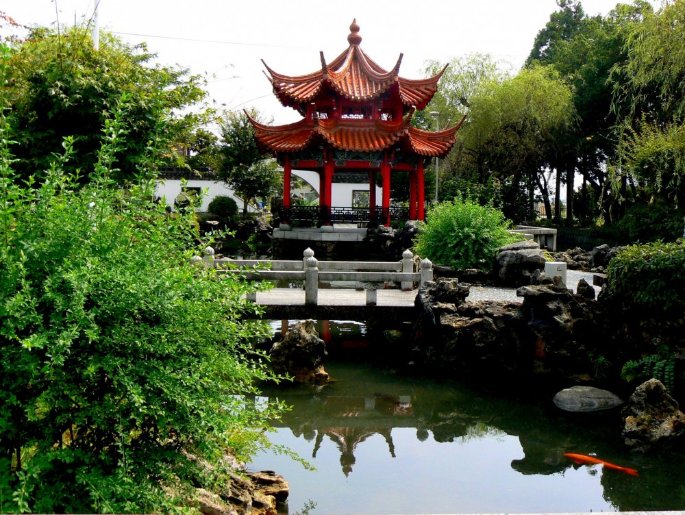 A bridge spans the pond near the pagoda