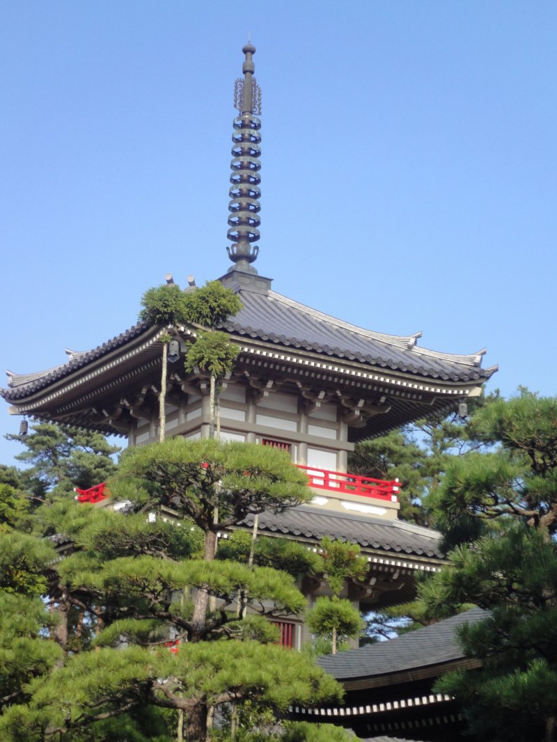 <p>A three storied pagoda stands in the Japanese garden of Rinno-ji</p>