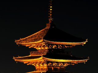 One of the landmarks of Kyoto, &#39;Yasaka Pagoda&#39;, looming in the dark in a golden hue
