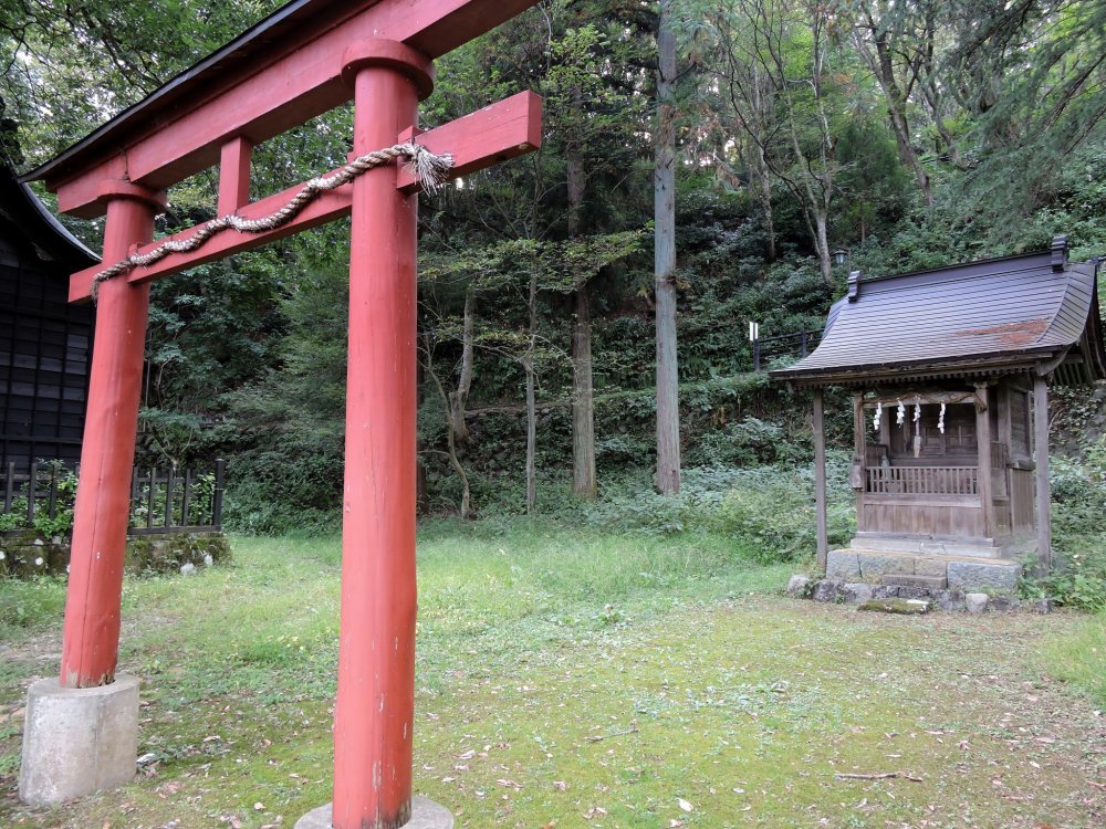Red torii gate in front of the small Inari Shrine