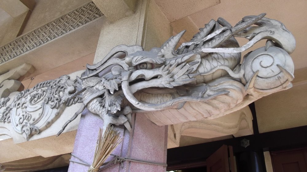 This fierce-looking dragon is just ready to swoop down on you from the eaves.