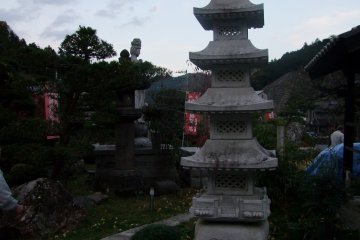 <p>A small pagoda with a scenic backdrop</p>