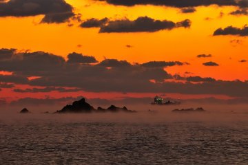 <p>Just before sunrise, a mysterious ship materialized offshore. Is this a tanker?</p>