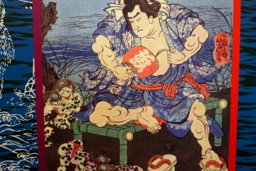 <p>Artwork of a samurai surrounded by playful kappa</p>