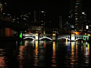 Beautiful Suisho (Crystal) Bridge over Dojima River with two types of arch creating an exquisite harmony. The lights reflected on the water surface are sparkling like crystal.