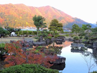 Japanese garden with colorful mountains in the background